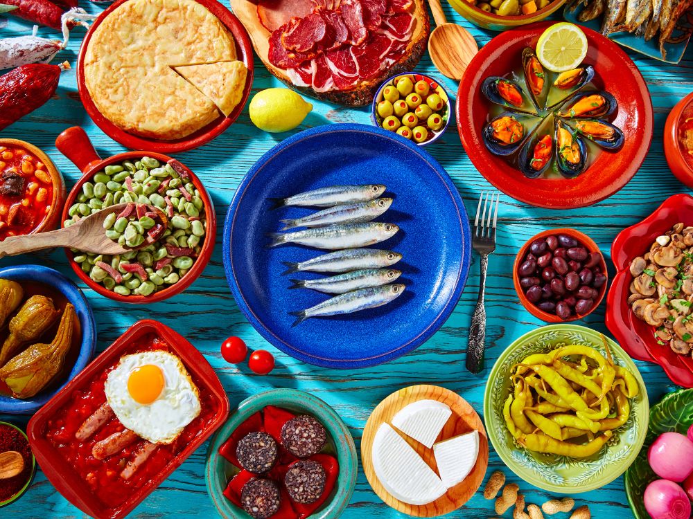 An aerial view of a colourful table full of of tapas dishes