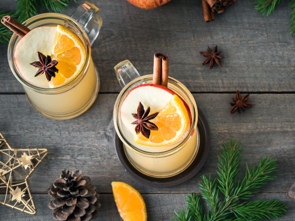 An overhead picture of two winter cocktails on a festive table