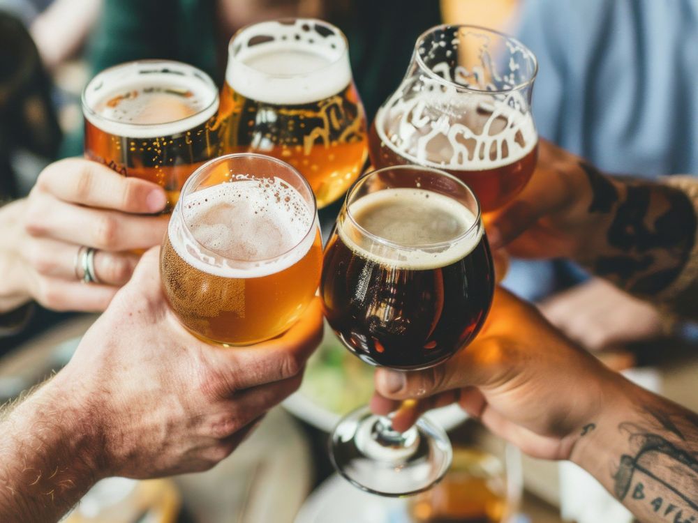 A group of men clink beer glasses