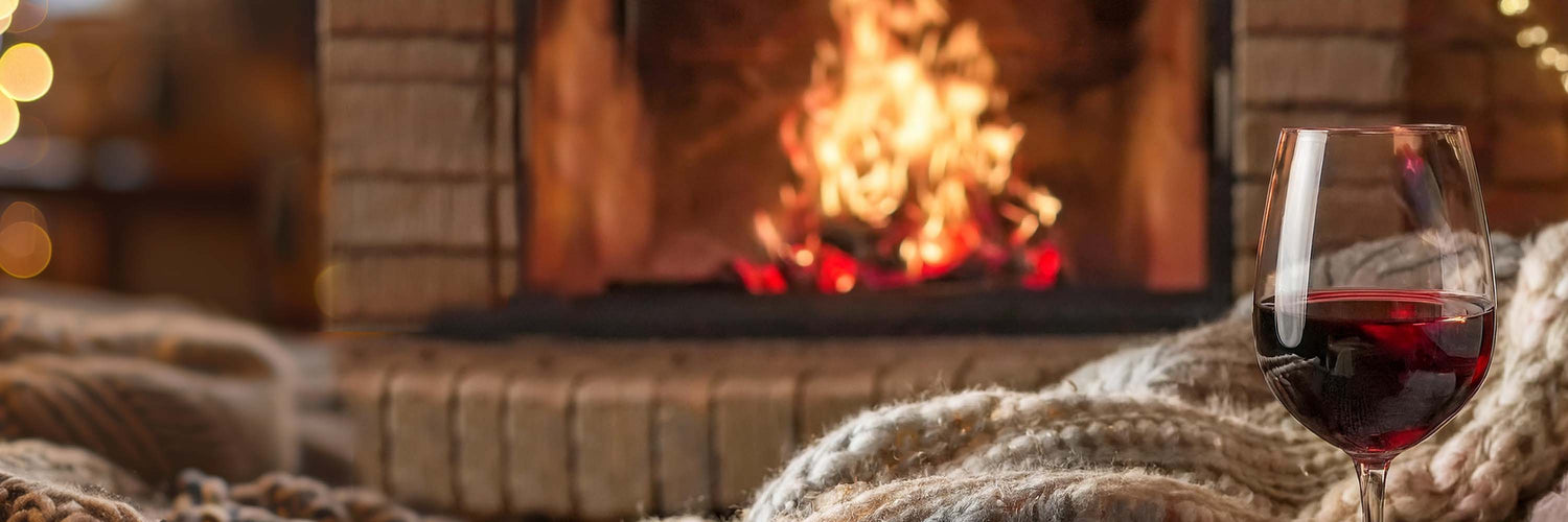 Red wine in front of a fireplace